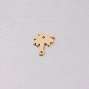 Detailed macro view of golden coconut tree pendant with mirror-polished finish for DIY jewelry
