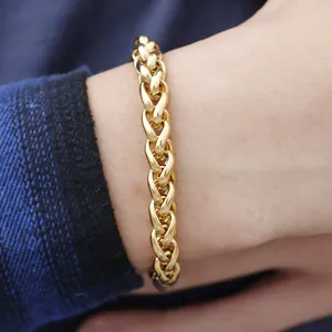Men's gold-plated stainless steel woven wheat chain bracelet worn on a male wrist