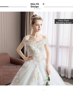 Detailed embroidery of floral lace on the off-shoulder champagne white wedding gown