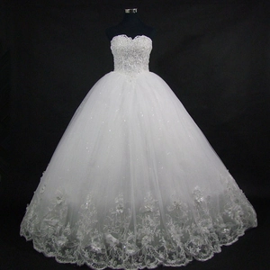 Detail of beaded lace bodice and floral embroidery on a white ball gown wedding dress