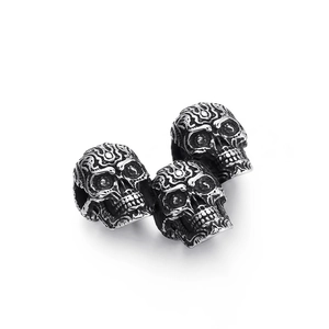 Three punk style silver skull pendants in titanium steel with detailed retro engravings