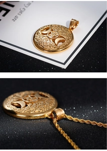 Macro detail of gold stainless steel Tree of Life pendant with Moon and Pentagram engraving