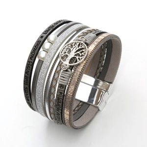 Close-up of leather wrap bracelet with Tree of Life charm and engraved inspirational words