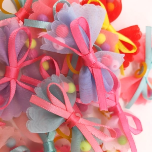 Colorful pet hair bows made of sheer mesh and satin ribbons with small beads inside