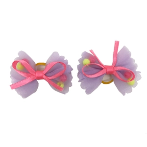 Detail of purple mesh and pink ribbon dog hair bows with yellow beads and rubber bands