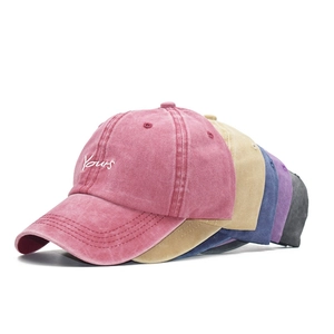Close-up of vintage washed cotton baseball caps showing multi-color stack and Yours embroidery