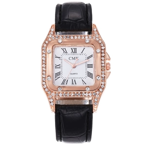Detail of rose gold square watch case with sparkling rhinestones and Roman numeral dial