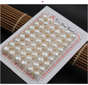 Macro shot of 40 pieces white round freshwater pearls arranged on a jewelry display card
