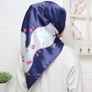 Navy blue satin silk square scarf with floral handbag print shown on a female model