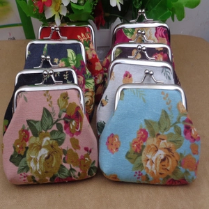 Close-up of vintage floral canvas coin purses with various patterns and metal clasps