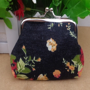 Close-up of vintage black floral canvas coin purse with silver metal kiss-lock closure