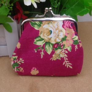 Detailed view of a vintage floral canvas coin purse with silver kiss-lock metal clasp