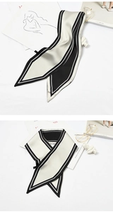 Detail view of black and white striped skinny silk scarf with elegant glossy finish