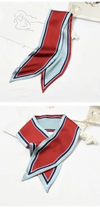 Detailed close-up of narrow satin silk scarf used for bag handles or hair styling