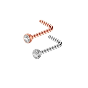 Detailed macro view of L-shaped stainless steel nose studs with round zircon in rose gold and silver