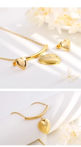 Detail of gold heart pendant necklace and matching stud earrings set with white flowers