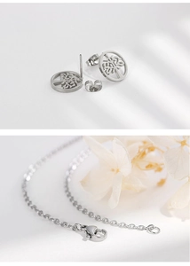 Close-up of silver Tree of Life earrings and necklace chain with lobster clasp