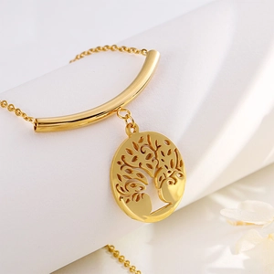 Elegant gold hollow tree of life necklace set on white background with floral accents