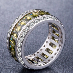 Detail of square-cut yellow gemstone ring with double-row micro-pave white zircon