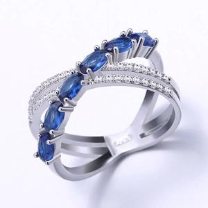 Elegant silver X-shape ring featuring blue oval stones and sparkling clear micro-pavé diamonds