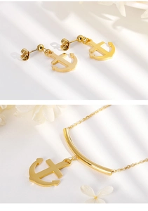 Detailed view of a gold plated anchor jewelry set with matching earrings and necklace