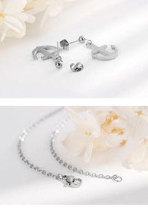 Detail view of silver anchor earrings and matching necklace chain with lobster clasp set