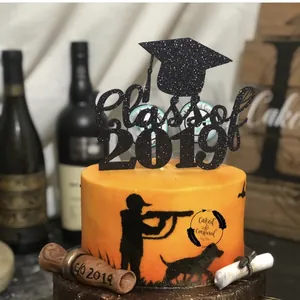 Sparkly black Class of 2019 cake topper with graduation cap and scroll on orange cake