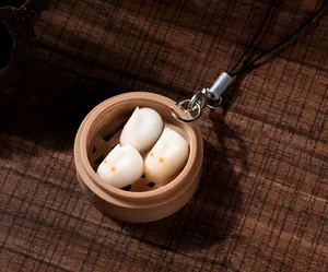 Detailed macro view of a miniature steamer with white rabbit-shaped dessert keychains