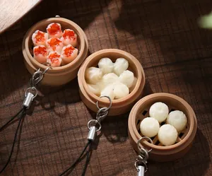 Detailed view of realistic resin dim sum charms with mini steamers and metal keyrings