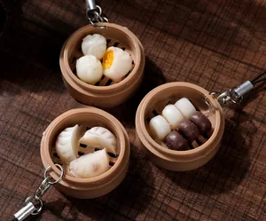 Detailed view of realistic ABS dessert charms featuring steamed buns and shrimp dumplings