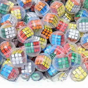 Bulk display of miniature puzzle cubes packed in 32-58mm clear plastic toy capsules