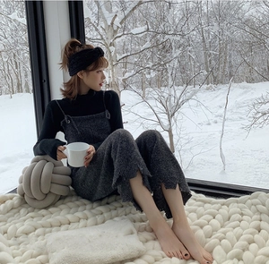 Detail showing high-quality knitted bow headband texture on a model in winter setting