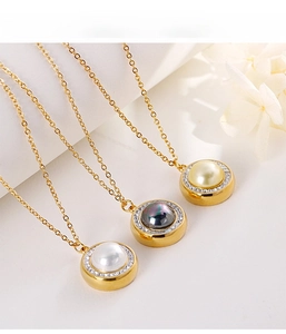Three elegant pearl pendant necklaces in white, black and gold colors with crystal border