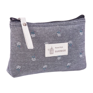 Floral dark gray canvas makeup bag with white flowers and a portable handle strap