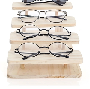 Front view of a 4-tier wooden glasses display stand with a natural tiered ladder design