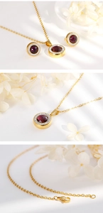 Detail of gold necklace and stud earrings set with red crystal and micro-pave diamonds