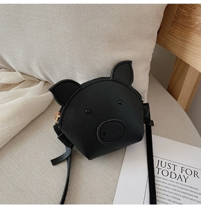 Detail of a black pig-shaped PU leather mini crossbody bag for kids with zipper closure