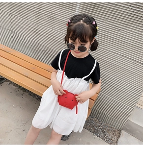 Toddler girl wearing a cute red pig-shaped crossbody bag with zipper and strap
