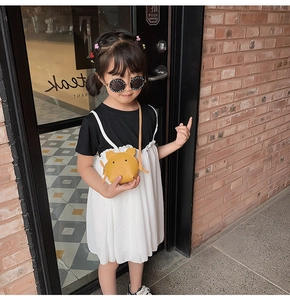 Toddler girl wearing casual dress and yellow animal cartoon crossbody bag outdoors