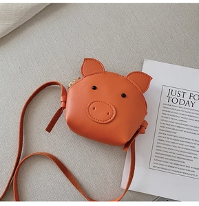 Detail of orange pig-shaped cartoon crossbody bag made of premium PU leather