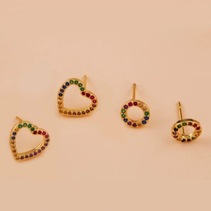 Detailed view of gold copper heart and round earrings set with colorful zircon stones