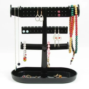 Black plastic jewelry display stand with tiers for necklaces earrings and storage tray