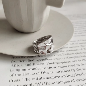 Macro shot of silver irregular lava texture wide open ring on aesthetic background