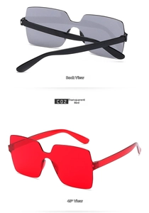 Detail view of one-piece square rimless sunglasses in transparent red and smoky grey lens
