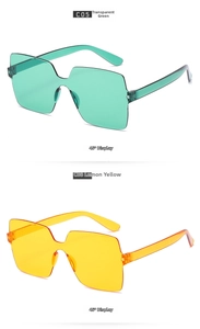 Close-up of translucent green and lemon yellow rimless square sunglasses at 45 degree angle