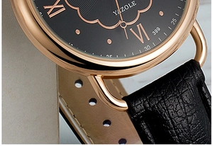 Close-up of Yazole quartz watch featuring rose gold case and black embossed leather strap