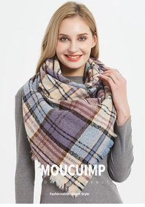 Detail shot of multicolor plaid scarf featuring purple and blue squares with fringe edges