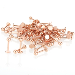 Rose gold stainless steel lip piercing studs with spike and ball ends on white background
