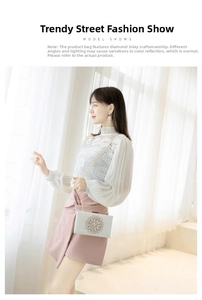 Close-up of elegant sparkling rhinestone sunflower buckle on white evening clutch bag