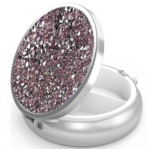 Detail view of the open round metal pill box with purple glitter top and two compartments